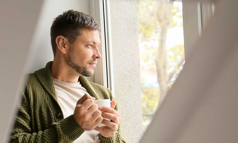 Man intensely looking the window
