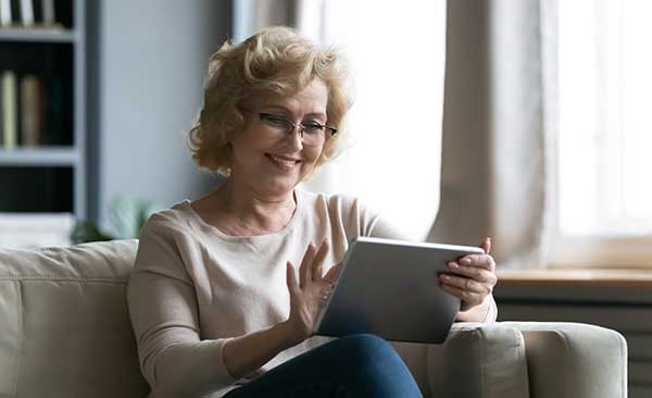 Woman smiling at her tablet