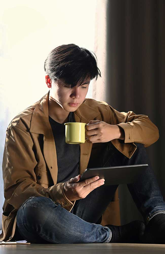 Individual engages in NHS talking therapy support via digital tablet.